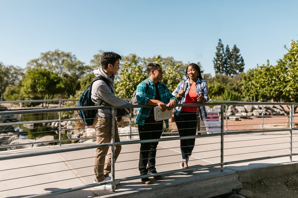 College students standing on a campus footbridge
