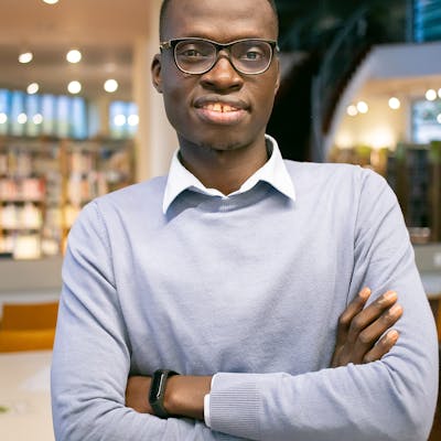 Confident man in formal outfit in a library